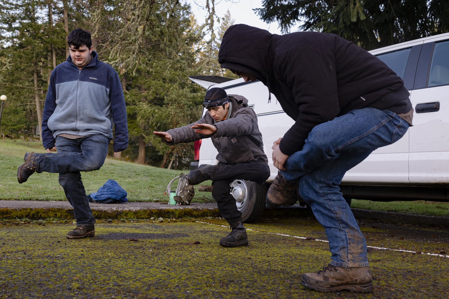 On their first day of doing fuel-reduction work as part of the Northwest Youth Corps’ pilot program, the Wildfire Workforce Corps, group members (from left to right) Joel Conaway, Jo-Jo- Morales, and Josh Wright stretch in a circle in front of the Fox Hollow Instructional Center. The daily ritual starts their work days in comradery, with mid-stretch conversations ranging from the day’s safety concerns, to favorite sandwiches and a world without social media.